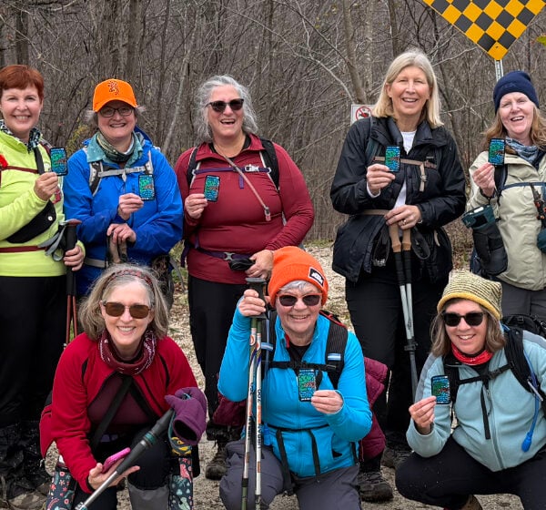 Cropped-close-up-ladies-holding-newly-earned-E2E-in-8-badges