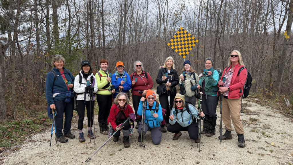 Ladies are all smiles as they show off their newly earned End-to-End in 8 badges at the end of their last hike.