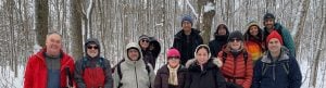 Snowshoe badge hikers posing for a photo on the trail during the second hike