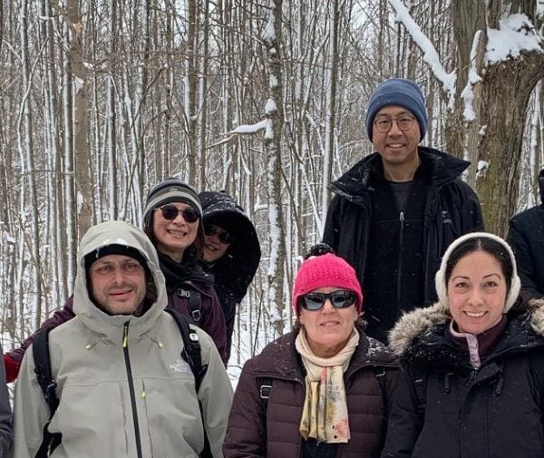 Snowshoe badge hikers posing for a photo on the trail during the second hike