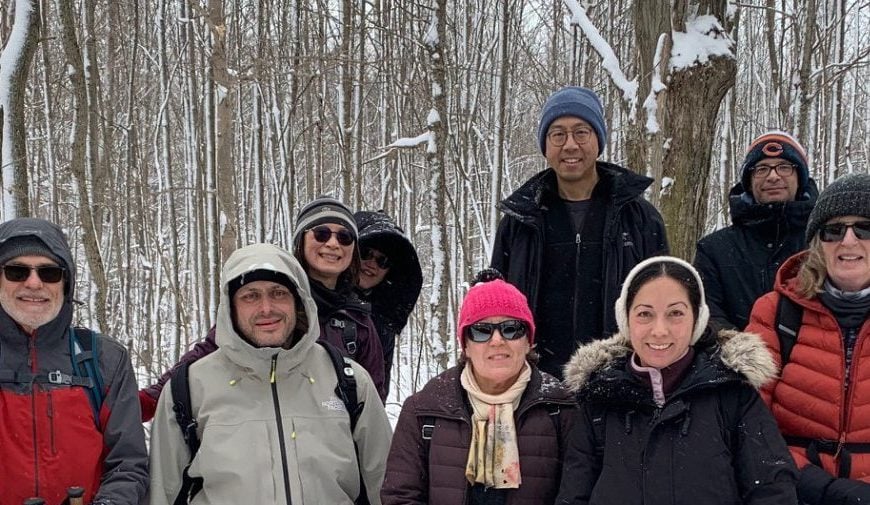 Snowshoe badge hikers posing for a photo on the trail during the second hike