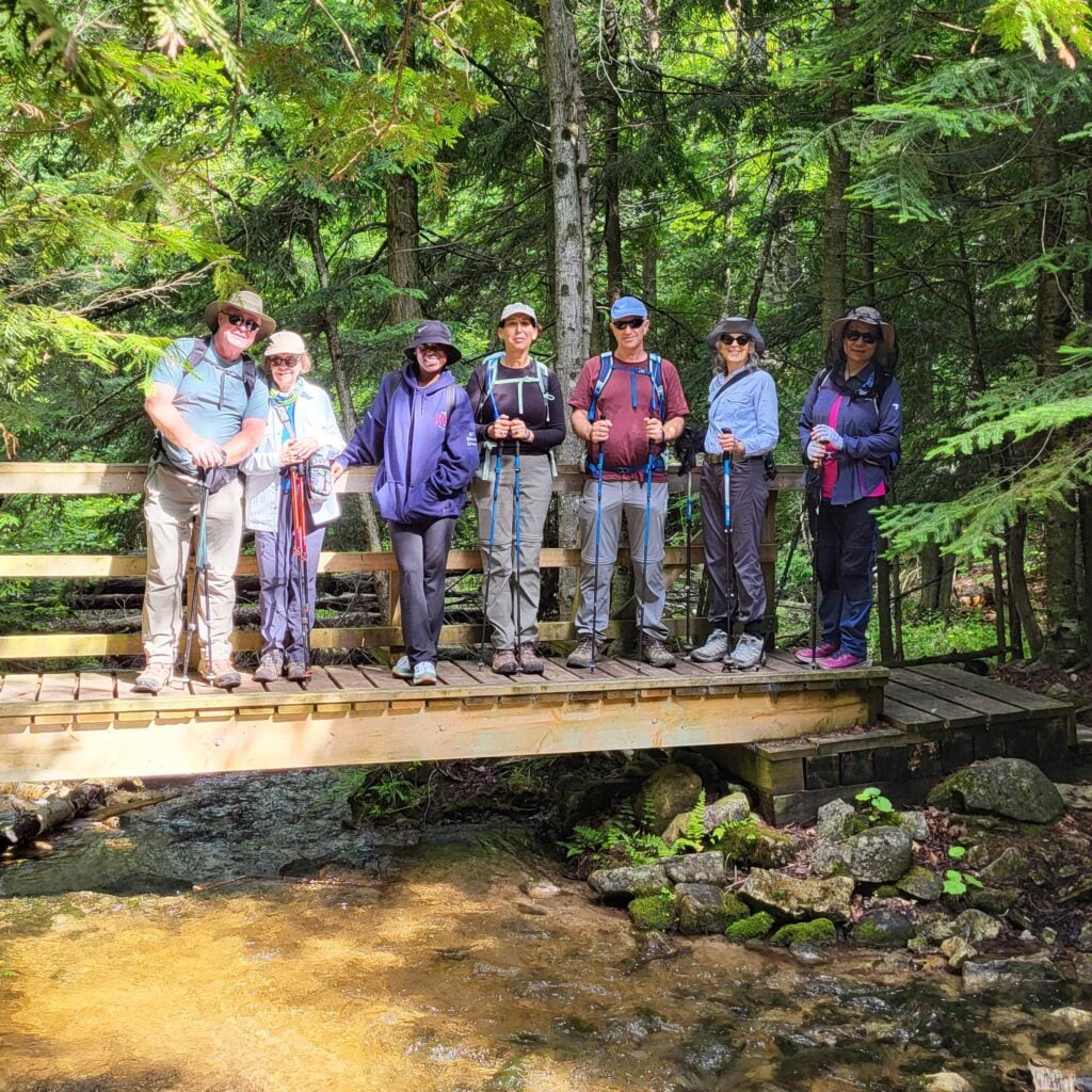 Our group is all smiles for a photo on a bridge along the hike from Eugenia Falls to Hogg's Falls and on to Johnston's Sideroad